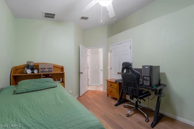 bedroom with light hardwood / wood-style floors and ceiling fan