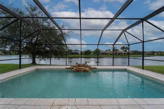 view of pool with a patio, a water view, and glass enclosure