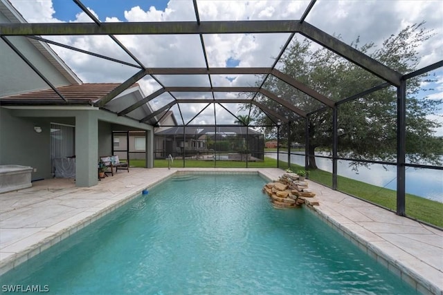 view of pool featuring glass enclosure and a patio area