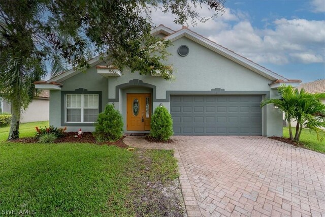 view of front of house with a garage and a front yard