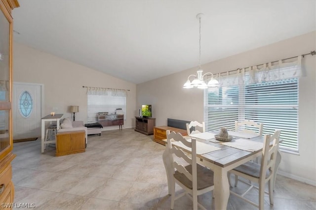 dining area with an inviting chandelier and lofted ceiling