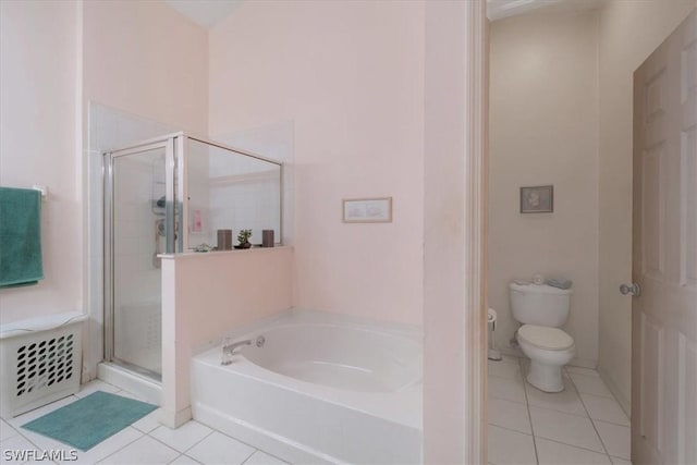 bathroom featuring tile patterned floors, toilet, and shower with separate bathtub