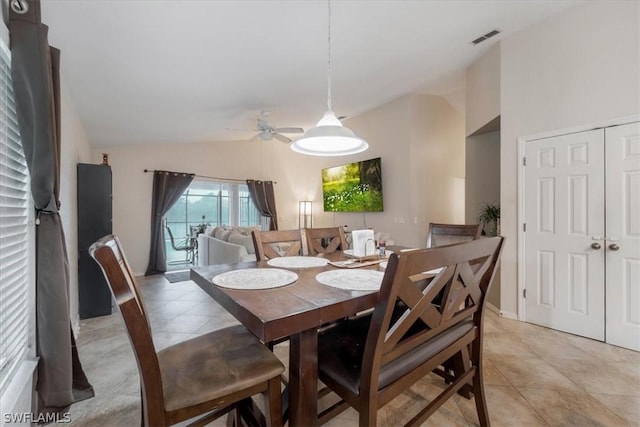 dining room featuring ceiling fan, lofted ceiling, and light tile patterned floors