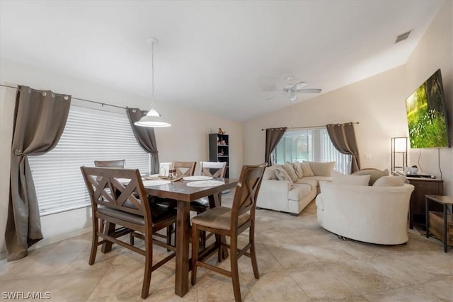 dining room with lofted ceiling, light tile patterned floors, and ceiling fan