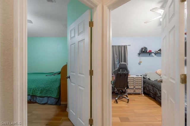 hallway with hardwood / wood-style flooring