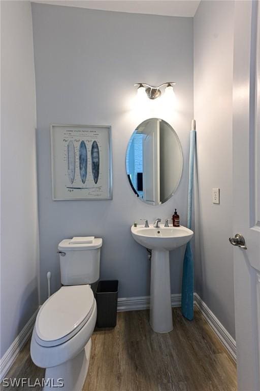 bathroom featuring sink, toilet, and hardwood / wood-style flooring