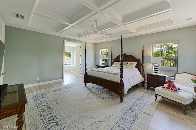 bedroom featuring light wood-type flooring, ensuite bathroom, multiple windows, and ceiling fan