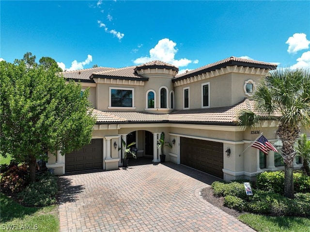 mediterranean / spanish home featuring a garage