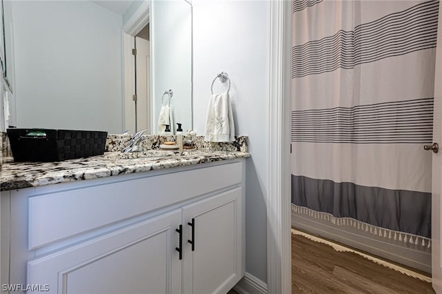 bathroom with vanity and wood-type flooring