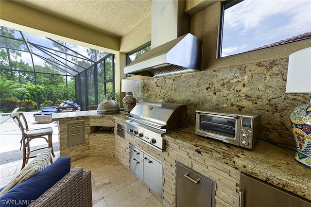 view of patio with an outdoor kitchen, grilling area, and glass enclosure