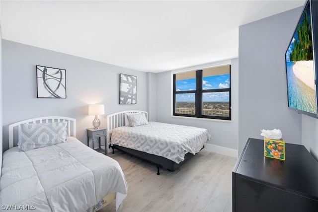 bedroom with hardwood / wood-style flooring