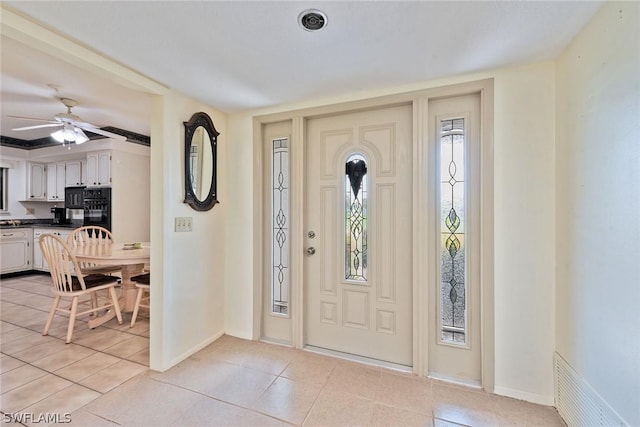 foyer entrance featuring ceiling fan and light tile patterned flooring