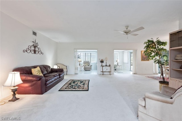 carpeted living room featuring ceiling fan