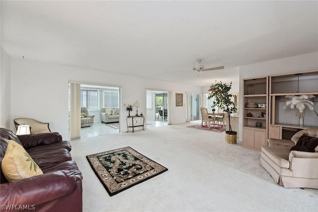 carpeted living room featuring ceiling fan