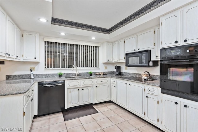 kitchen featuring black appliances, light tile patterned floors, sink, and white cabinetry