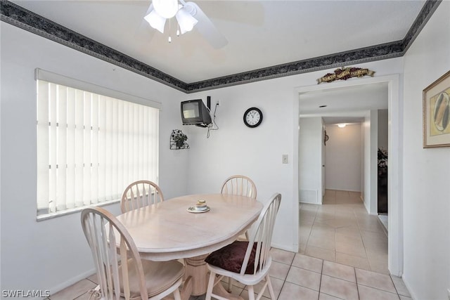 dining space featuring ceiling fan and light tile patterned flooring