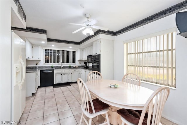 kitchen with light tile patterned floors, ceiling fan, black appliances, white cabinets, and sink