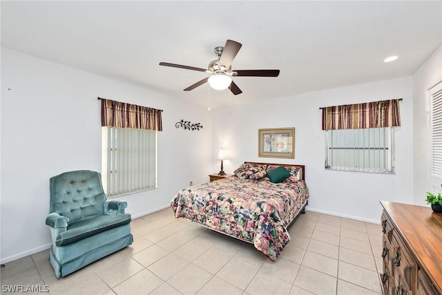 tiled bedroom featuring ceiling fan