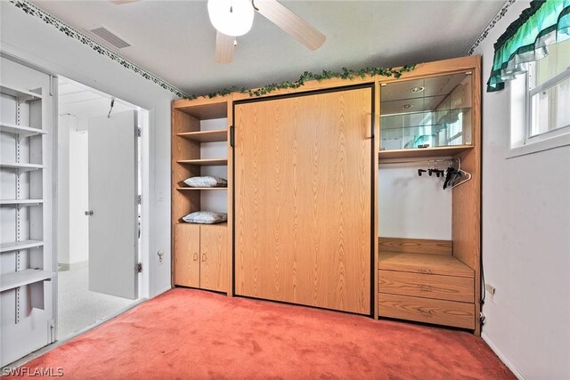 unfurnished bedroom featuring ceiling fan and carpet flooring