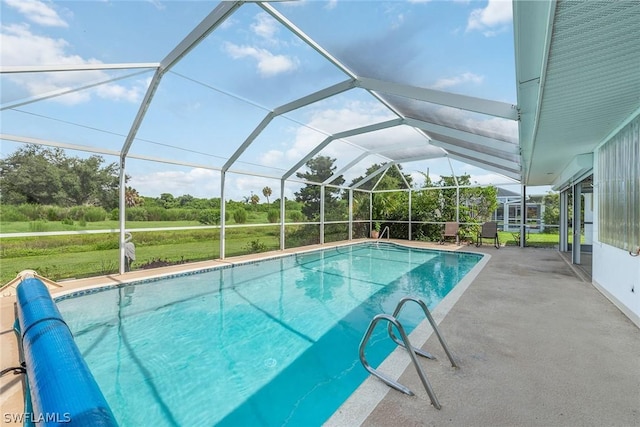 view of pool with a lanai, a yard, and a patio