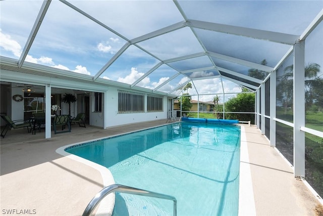 view of pool with a lanai and a patio