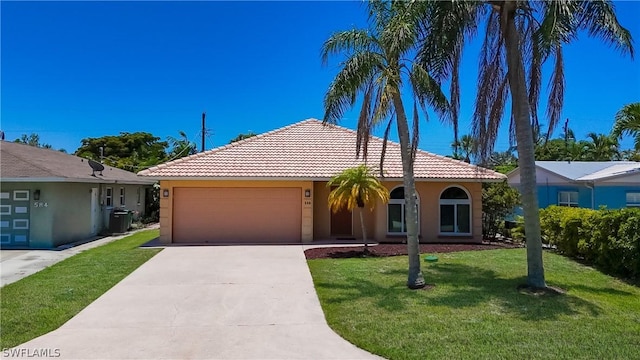 view of front of home with a front lawn and a garage