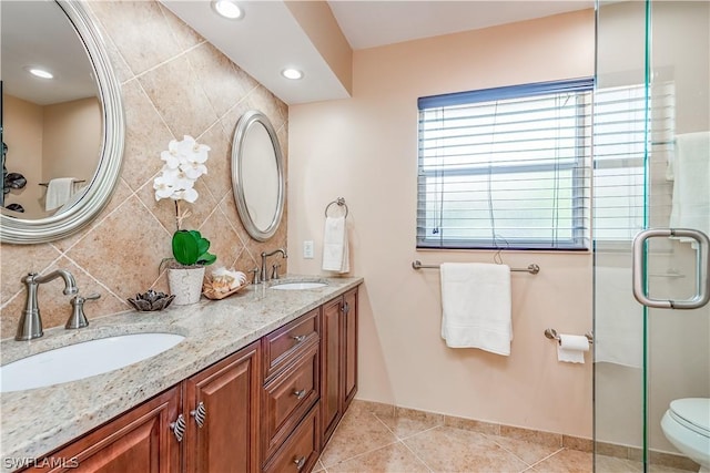 bathroom with vanity, tile patterned flooring, toilet, tasteful backsplash, and an enclosed shower