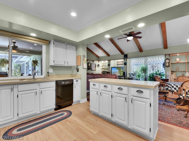 kitchen with sink, black dishwasher, light hardwood / wood-style flooring, lofted ceiling with beams, and white cabinets