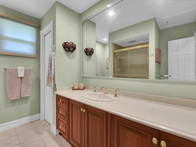 bathroom featuring tile patterned flooring, vanity, and a shower with shower door