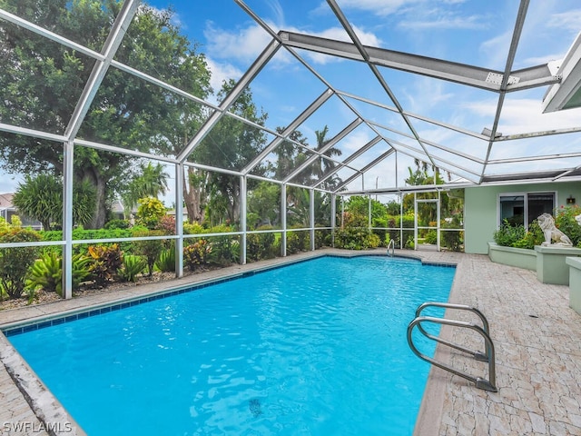 view of swimming pool with a lanai and a patio area