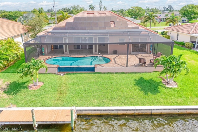 view of pool featuring a lawn, glass enclosure, a water view, and a patio