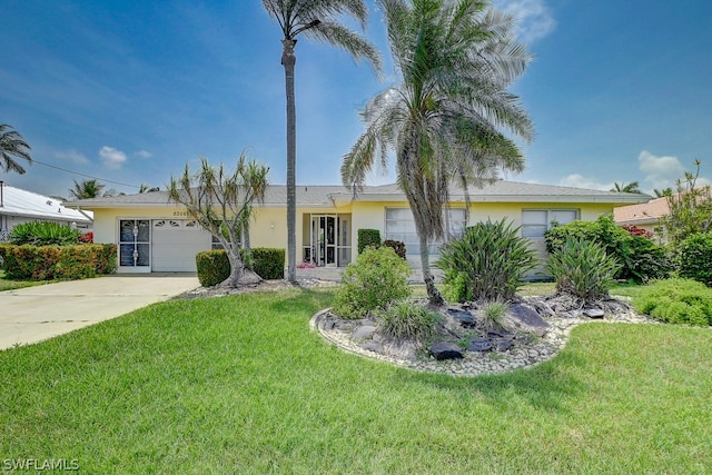 view of front of house featuring a garage and a front lawn