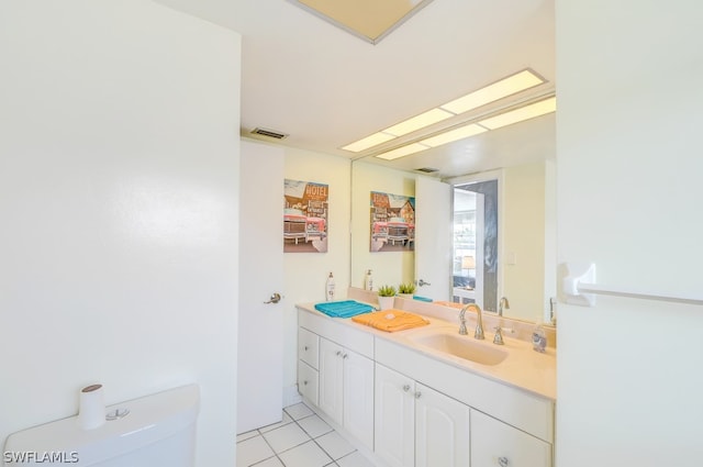 bathroom with vanity, tile patterned flooring, and toilet