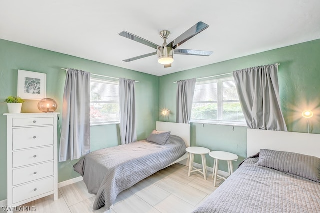 bedroom with multiple windows and ceiling fan