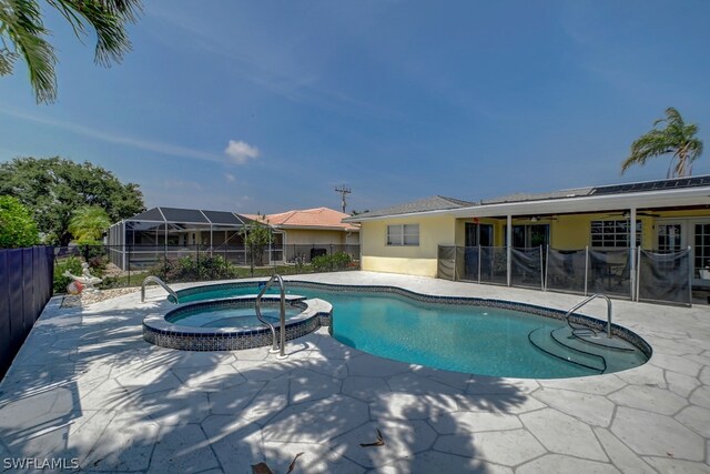 view of pool featuring a patio and an in ground hot tub