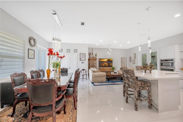 dining area featuring light tile floors