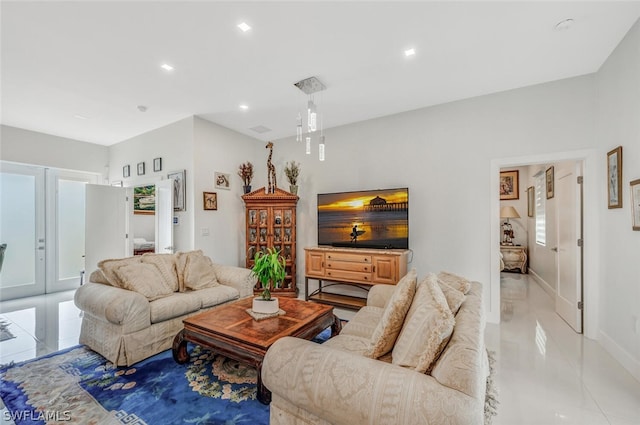 living room featuring a healthy amount of sunlight and light tile floors