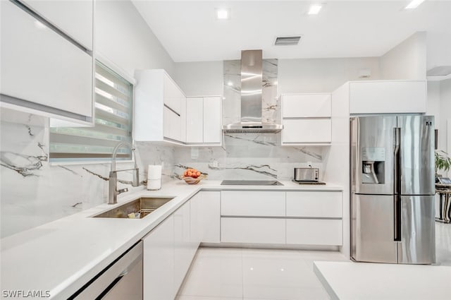 kitchen with wall chimney exhaust hood, light tile floors, white cabinetry, and appliances with stainless steel finishes