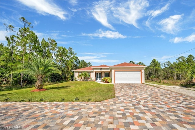 view of front of home with a garage and a front lawn