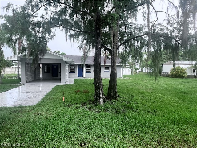 ranch-style home with a front lawn and a carport