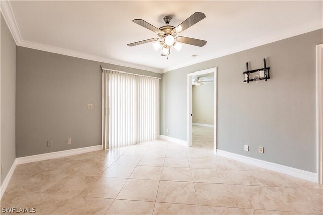 empty room with ornamental molding, ceiling fan, and light tile floors