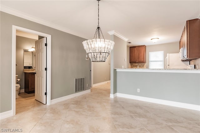 interior space with hanging light fixtures, light stone countertops, an inviting chandelier, white appliances, and light tile floors