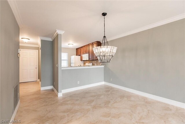 unfurnished dining area featuring crown molding, light tile floors, and a chandelier