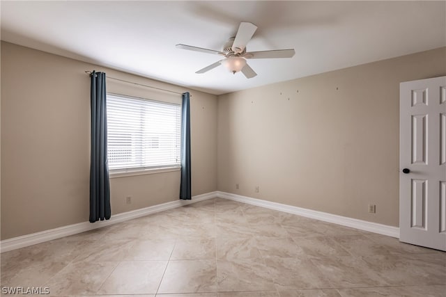 unfurnished room with ceiling fan and light tile floors