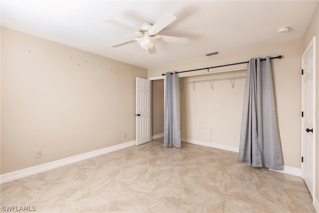 unfurnished bedroom with ceiling fan, a closet, and light tile flooring