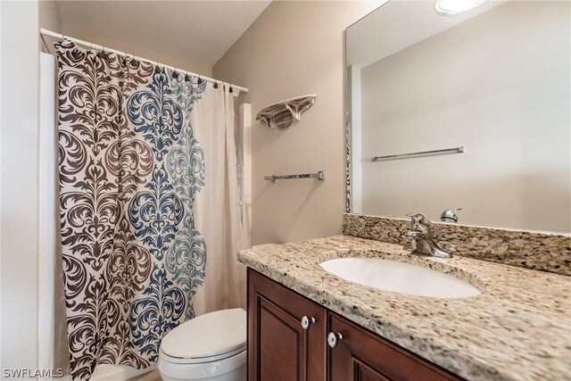 bathroom with vanity with extensive cabinet space and toilet