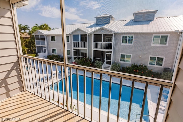 balcony with a fenced in pool