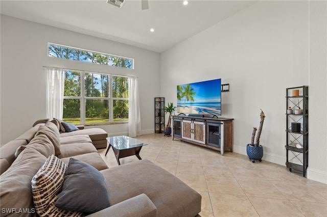 tiled living room featuring a high ceiling