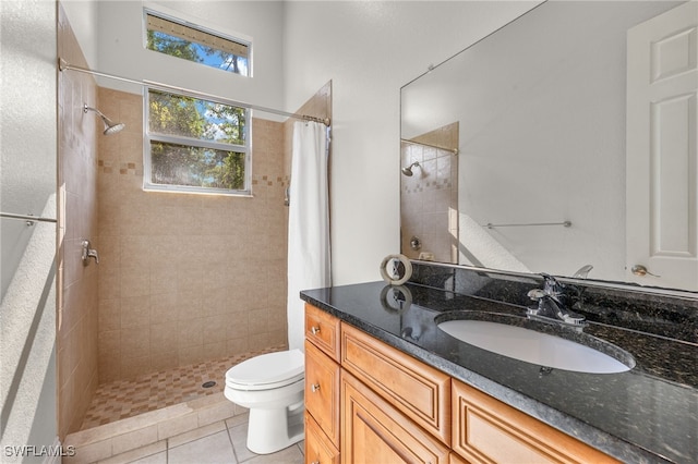 bathroom featuring curtained shower, toilet, vanity, and tile patterned flooring