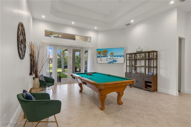 playroom with a tray ceiling, a high ceiling, pool table, and french doors